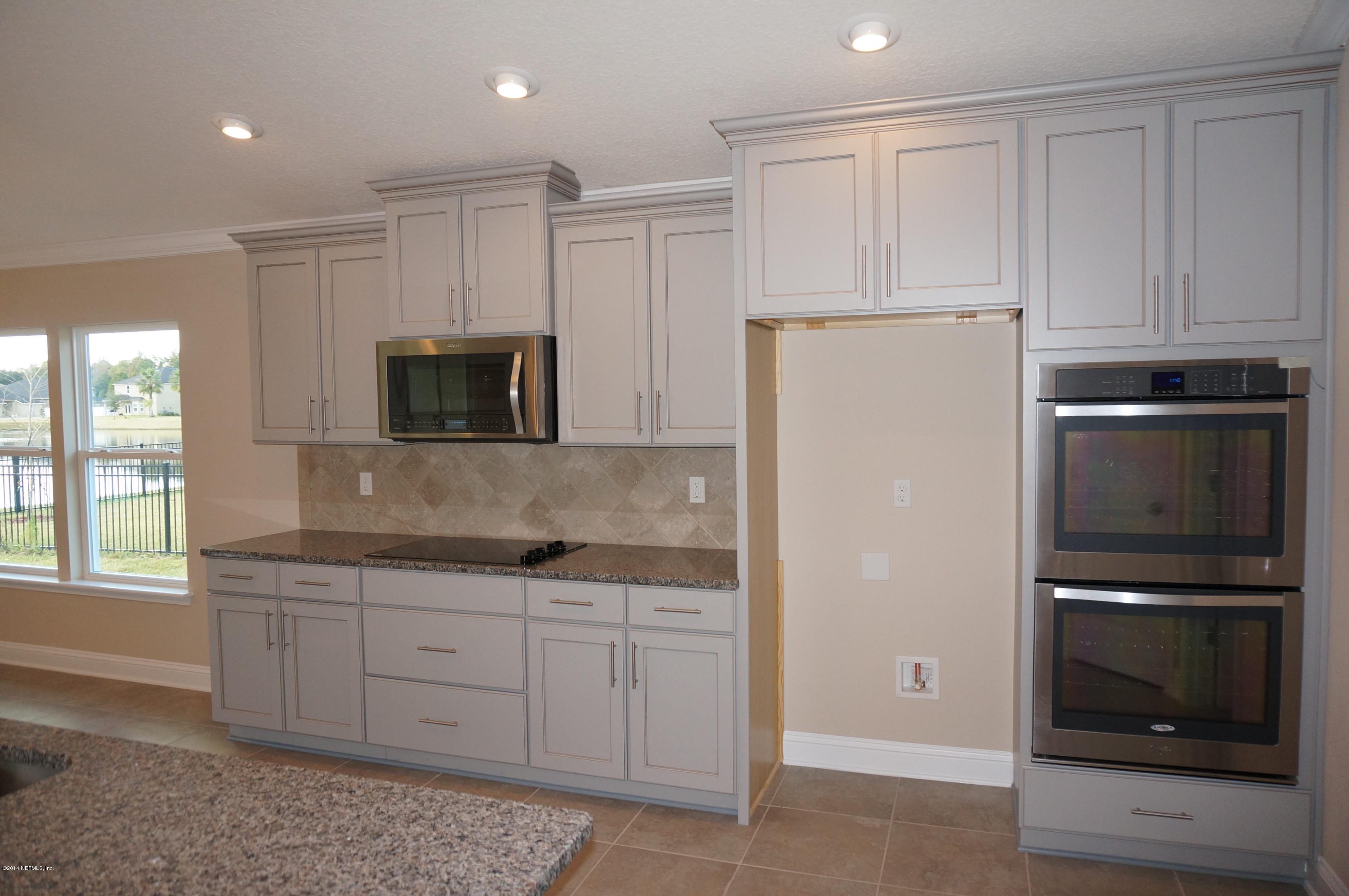 159 Prince Albert Avenue St. Johns, FL 32259 - Photo 26 of 43 a kitchen with a refrigerator sink and cabinets