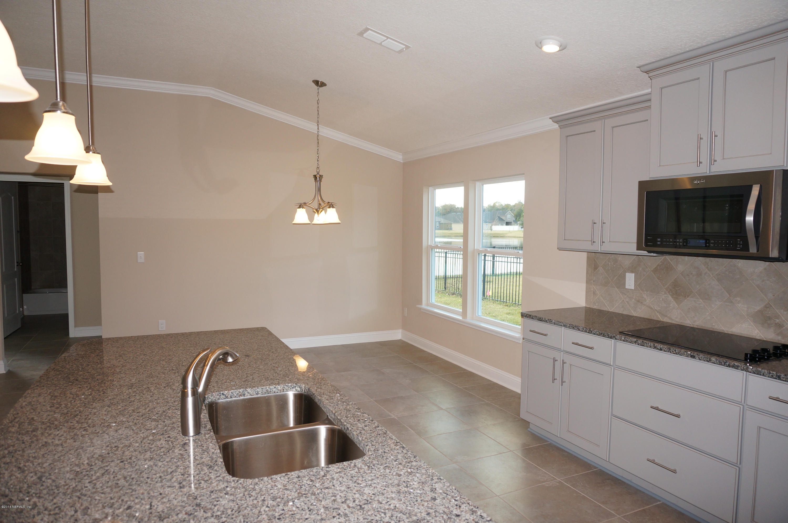 159 Prince Albert Avenue St. Johns, FL 32259 - Photo 28 of 43 a kitchen with stainless steel appliances granite countertop a sink and a microwave
