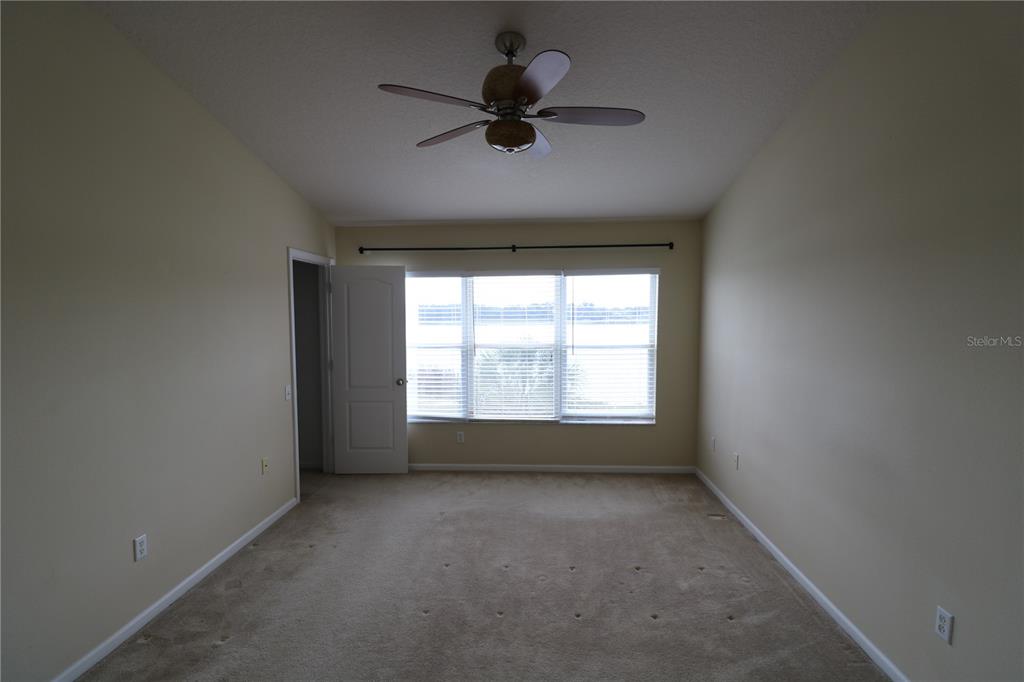 4866 Pond Ridge Drive Riverview, FL 33578 - Photo 25 of 38 a view of room with a ceiling fan and window