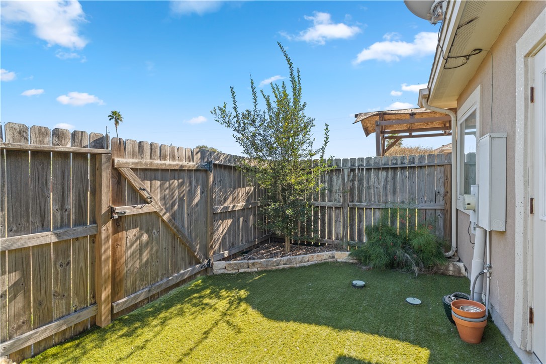 6934 Wooldridge Road, Unit K Corpus Christi, TX 78414 - Photo 20 of 20 a view of a backyard with plants and wooden fence