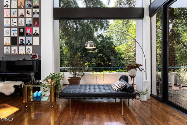a view of a patio with table and chairs potted plants with wooden floor