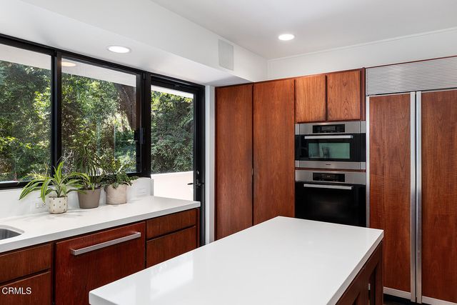a kitchen with stainless steel appliances a refrigerator sink and stove