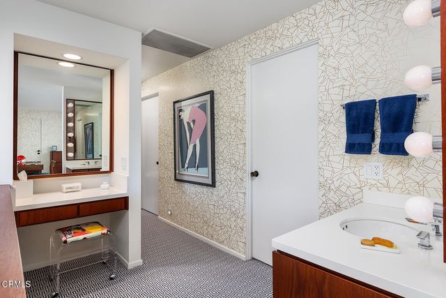 a view of bathroom with a sink and a mirror