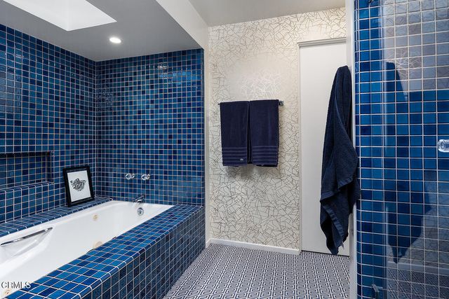 a bathroom with a bathtub and a shower