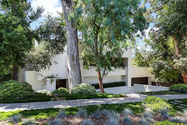 a front view of a house with garden