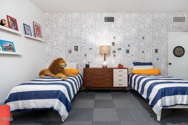 a bedroom with a bed and a lamp