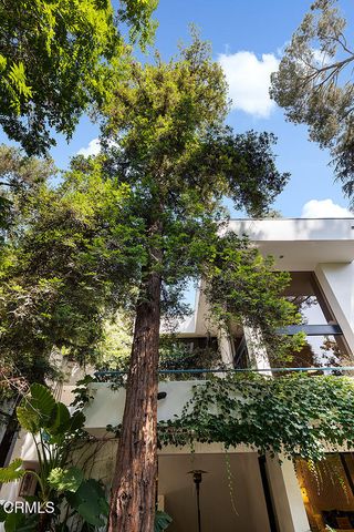 a view of a patio with a table and chairs under an umbrella