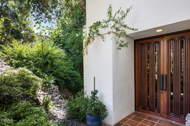 a view of a house with a flower garden