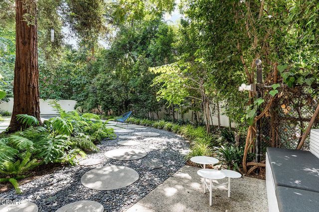 a view of a yard with table and chairs