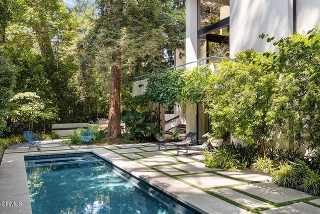 a view of a house with backyard and sitting area