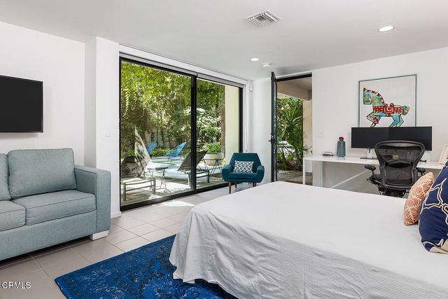 a large white bed in a white room