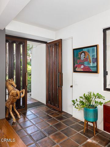 a view of a workspace with furniture and a potted plant
