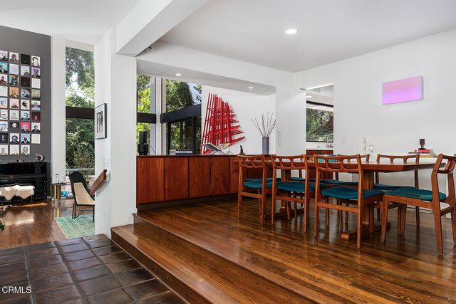 a living room with furniture a rug and a floor to ceiling window