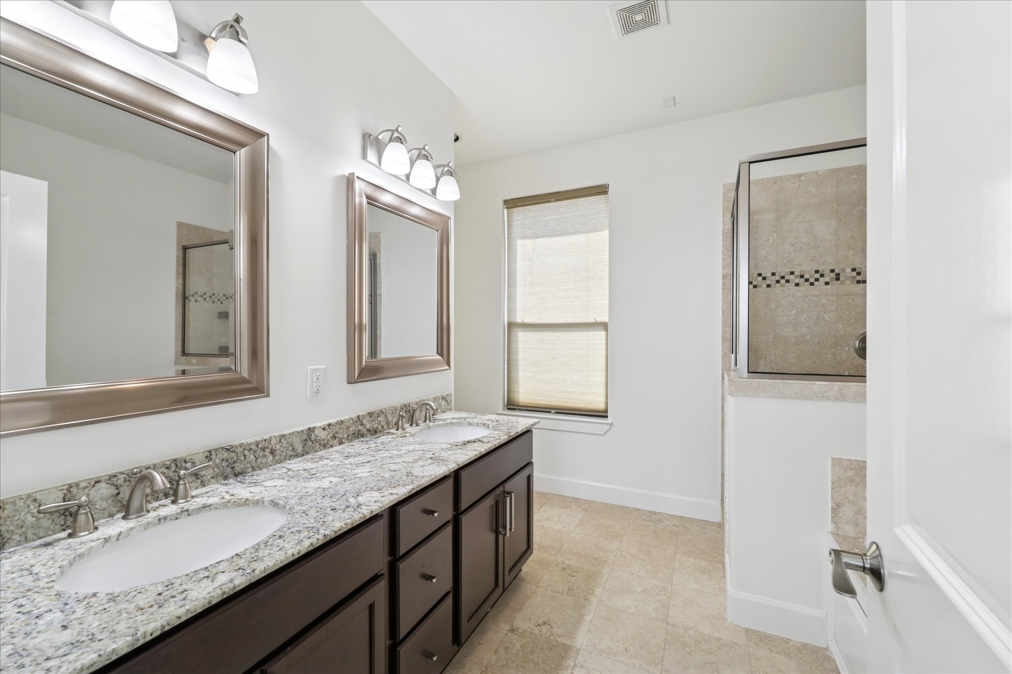 830 West 19th Street, Unit B Houston, TX 77008 - Photo 21 of 38 a bathroom with a granite countertop double vanity sink and a mirror