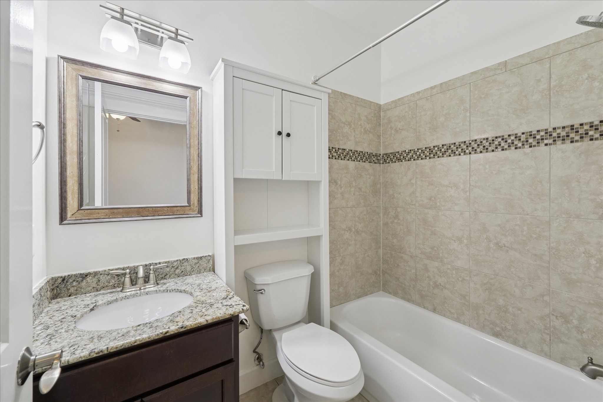 830 West 19th Street, Unit B Houston, TX 77008 - Photo 7 of 38 a bathroom with a granite countertop toilet sink and mirror