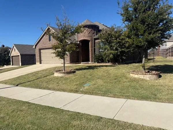 a front view of a house with yard
