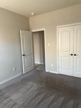 a view of a room with a ceiling fan and window