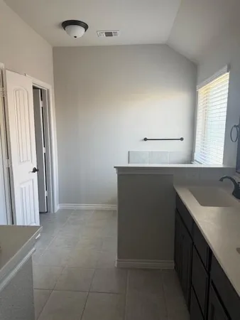 a kitchen with a sink and a refrigerator