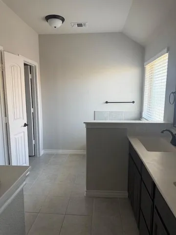 a kitchen with a sink and a refrigerator