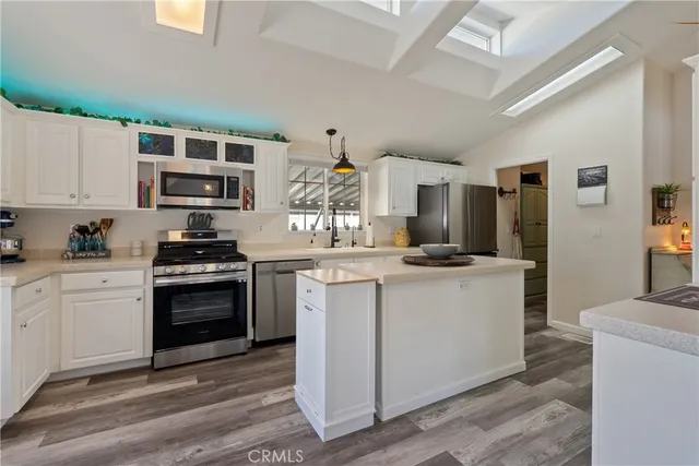 a kitchen with stainless steel appliances granite countertop a stove and a sink