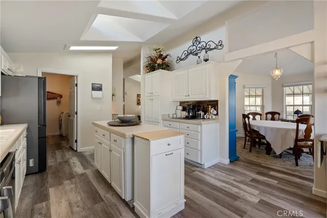 a kitchen with a refrigerator and a stove top oven