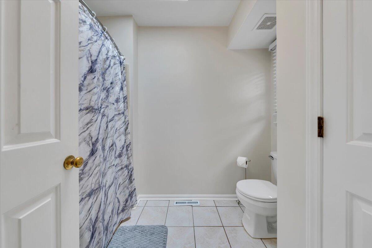 7851 Cedar Edge Road Roanoke, VA 24018 - Photo 18 of 44 a bathroom with a toilet and shower