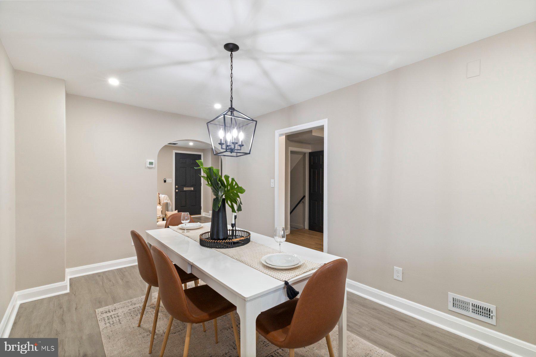 1659 Thetford Road Towson, MD 21286 - Photo 7 of 25 a view of a dining room with furniture a chandelier and wooden floor