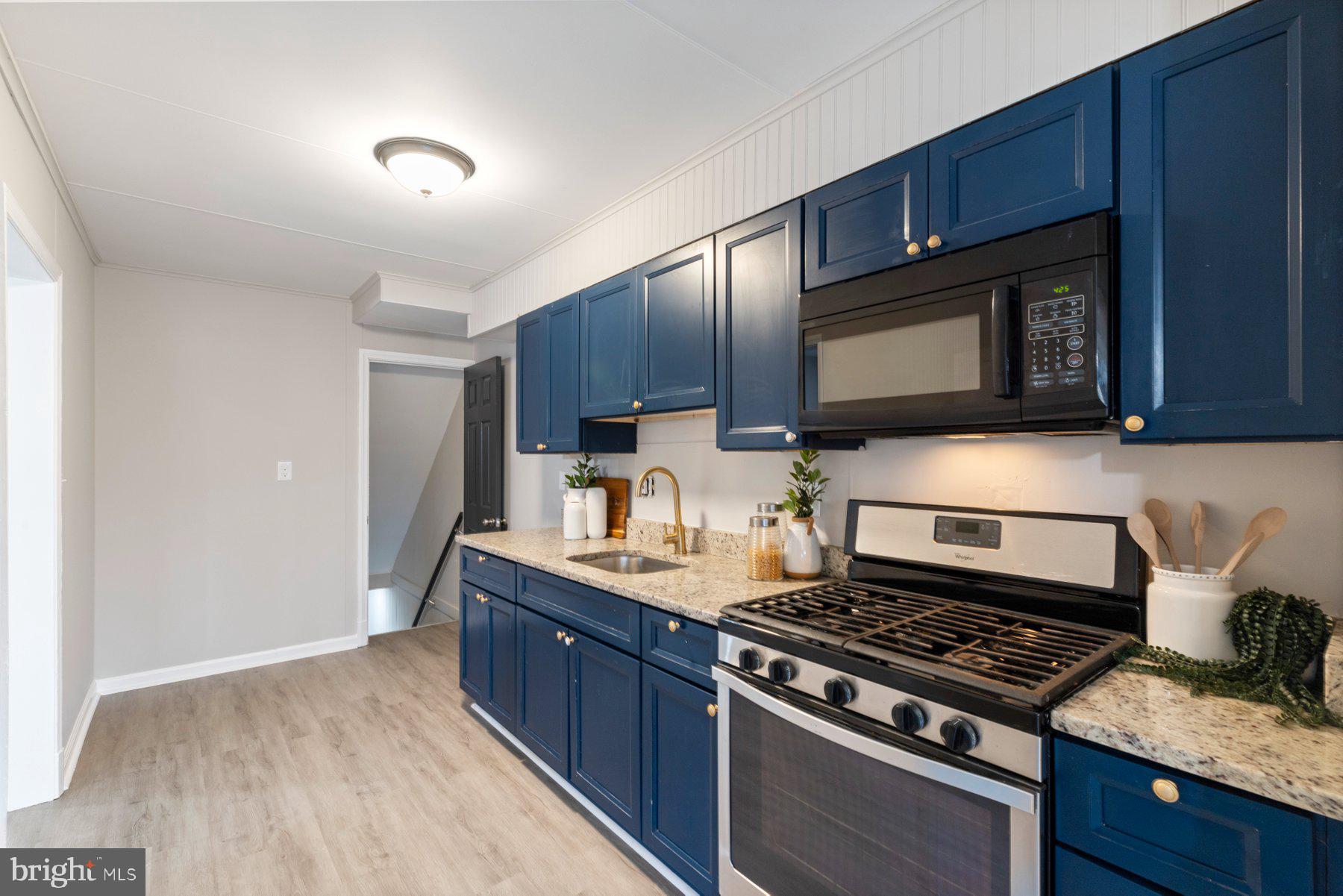 1659 Thetford Road Towson, MD 21286 - Photo 10 of 25 a kitchen with stainless steel appliances wooden cabinets and a stove top oven