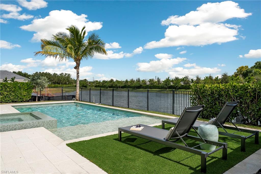 6704 Newport Road Naples, FL 34109 - Photo 38 of 47 a view of a patio with a table chairs and a palm tree
