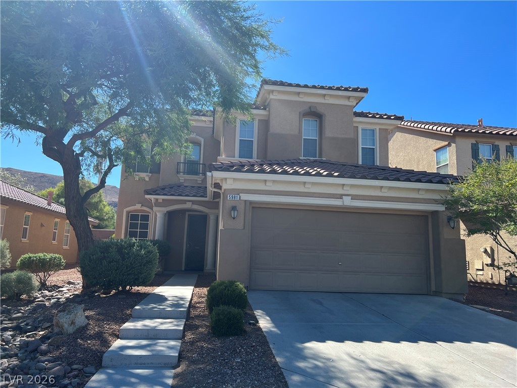 5981 Honeysuckle Ridge Street Las Vegas, NV 89148 - Photo 2 of 29 A charming stucco exterior welcomes with a two-car garage and manicured front yard.