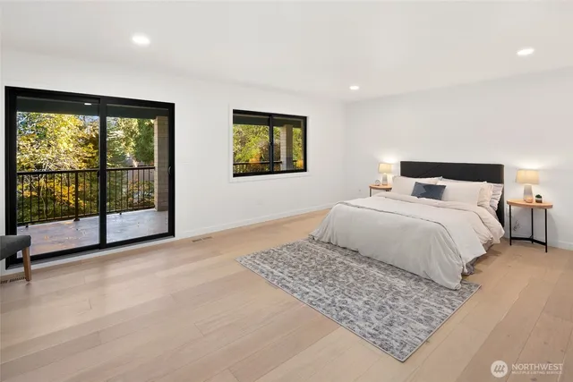 a bedroom with a large bed and a large window