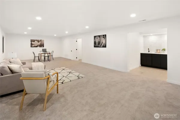 a living room with furniture and a kitchen