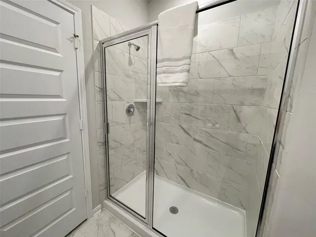 a bathroom with a glass shower door
