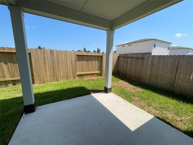 a view of a back yard with a wooden fence