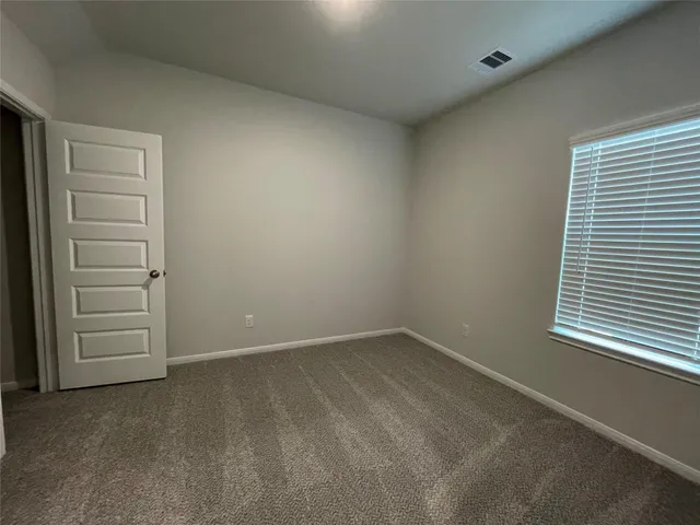 a view of an empty room and a window