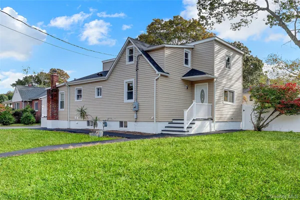 a front view of house with yard and green space