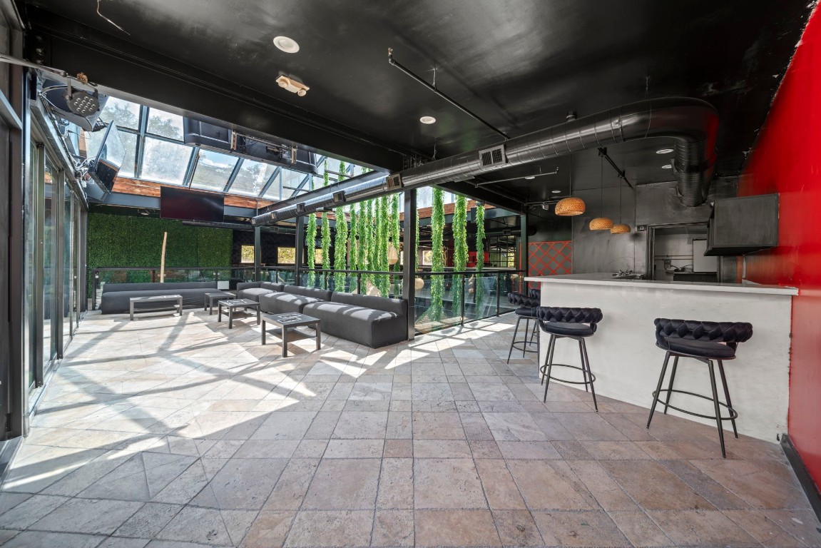 1916 Baldwin Street Houston, TX 77019 - Photo 17 of 37 a view of a patio with a table and chairs under an umbrella with a glass door