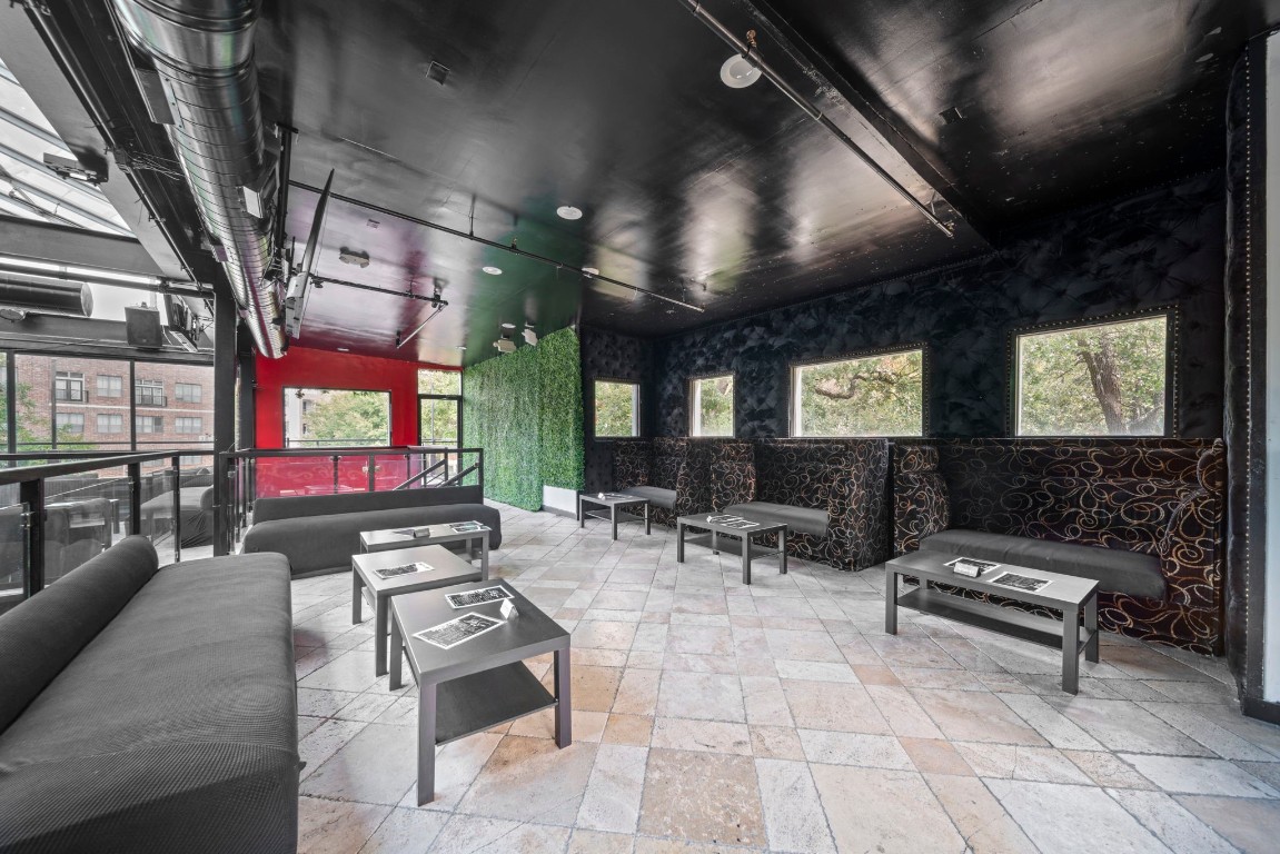 1916 Baldwin Street Houston, TX 77019 - Photo 22 of 37 a outdoor space with lots of tables a large window and chairs