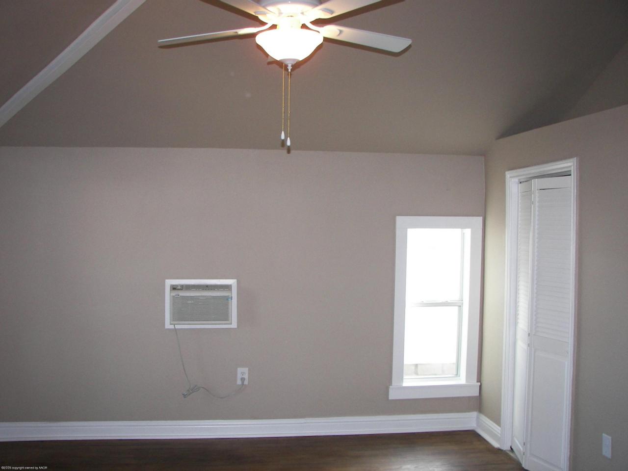 2002 8th Avenue Canyon, TX 79015 - Photo 5 of 6 an empty room with windows and fan