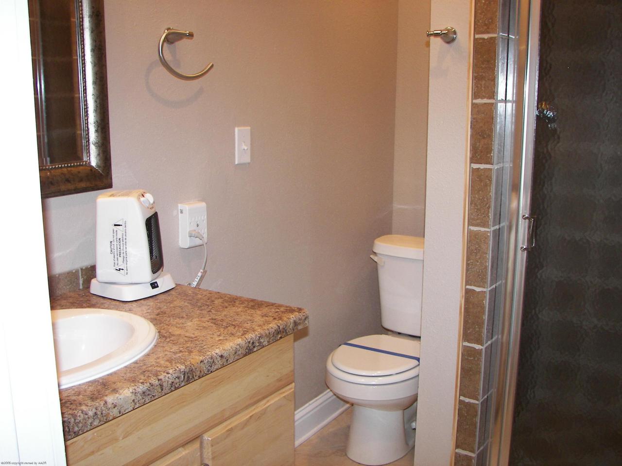2002 8th Avenue Canyon, TX 79015 - Photo 6 of 6 a bathroom with a granite countertop toilet and a sink