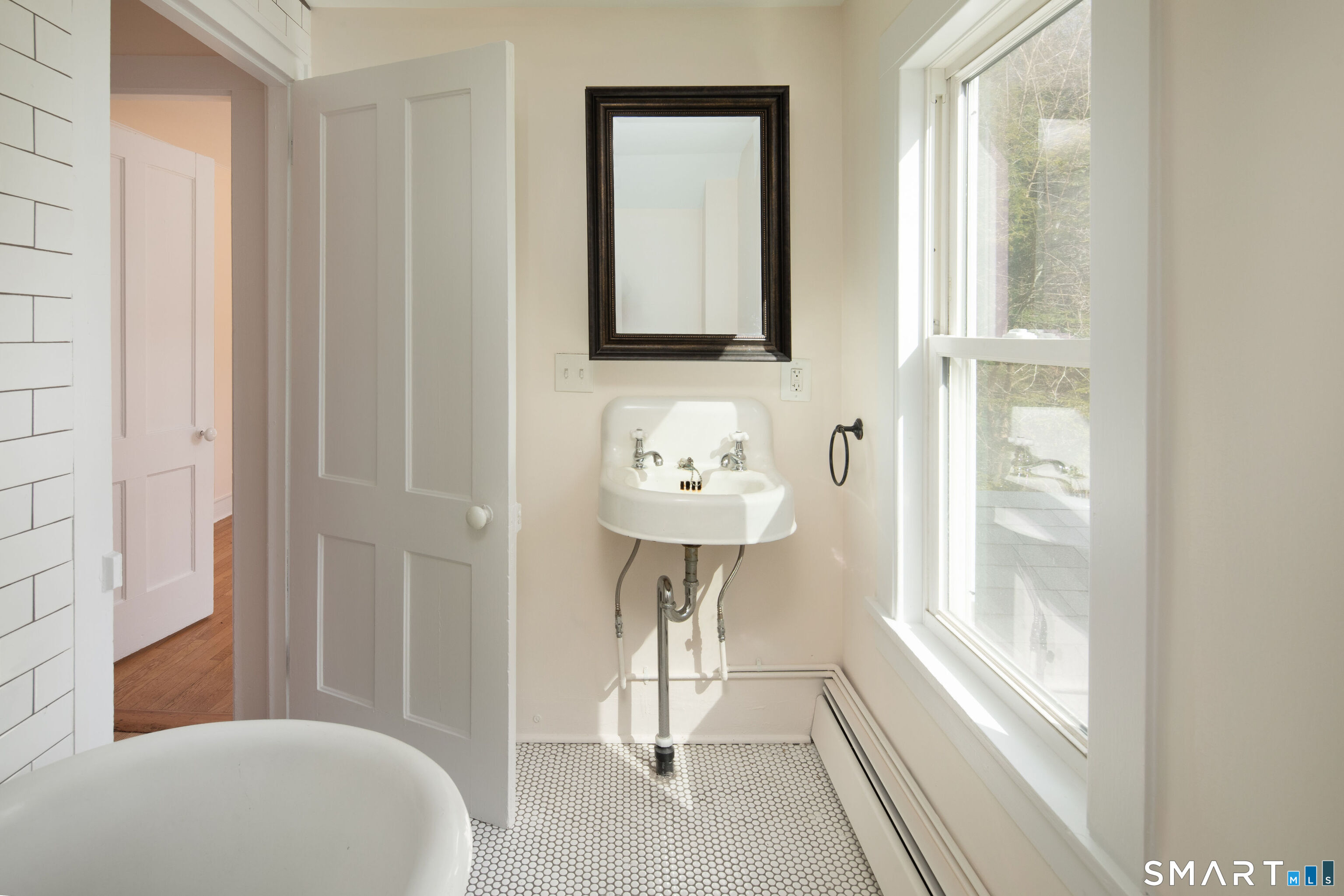 59 Prospect Street Canaan, CT 06031 - Photo 16 of 22 a bathroom with a sink a mirror and a shower