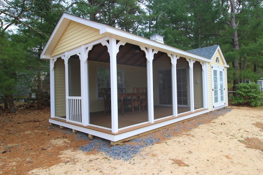 2 Helminth Avenue Wareham, MA 02571 - Photo 21 of 38 a view of a white house with a large windows and plants