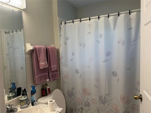 a bathroom with a shower curtain and a sink