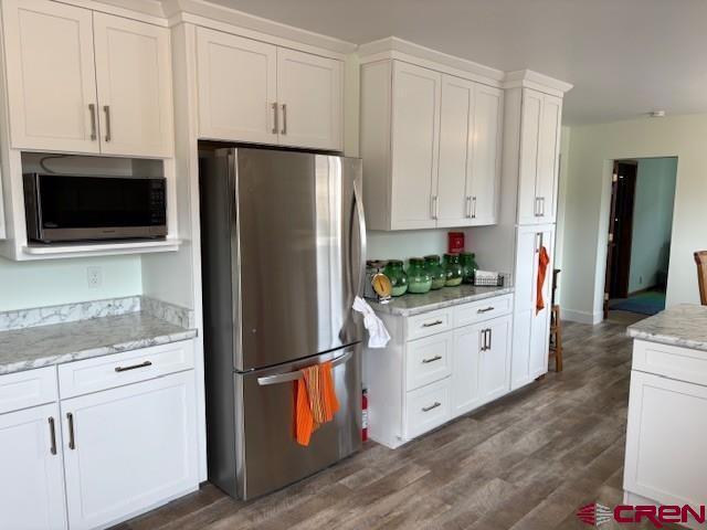 15736 2600th Road Cedaredge, CO 81413 - Photo 14 of 42 a kitchen with white cabinets and stainless steel appliances