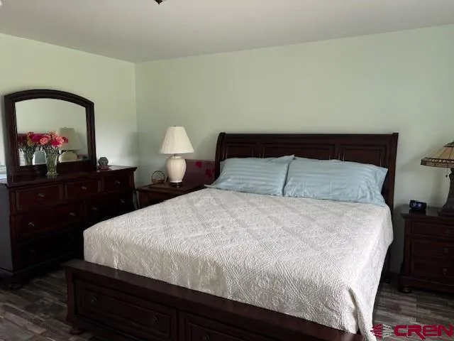 a bedroom with a bed and a dresser