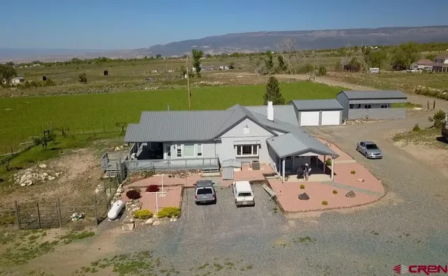 an aerial view of a house with outdoor space