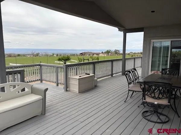 a view of a roof deck with furniture