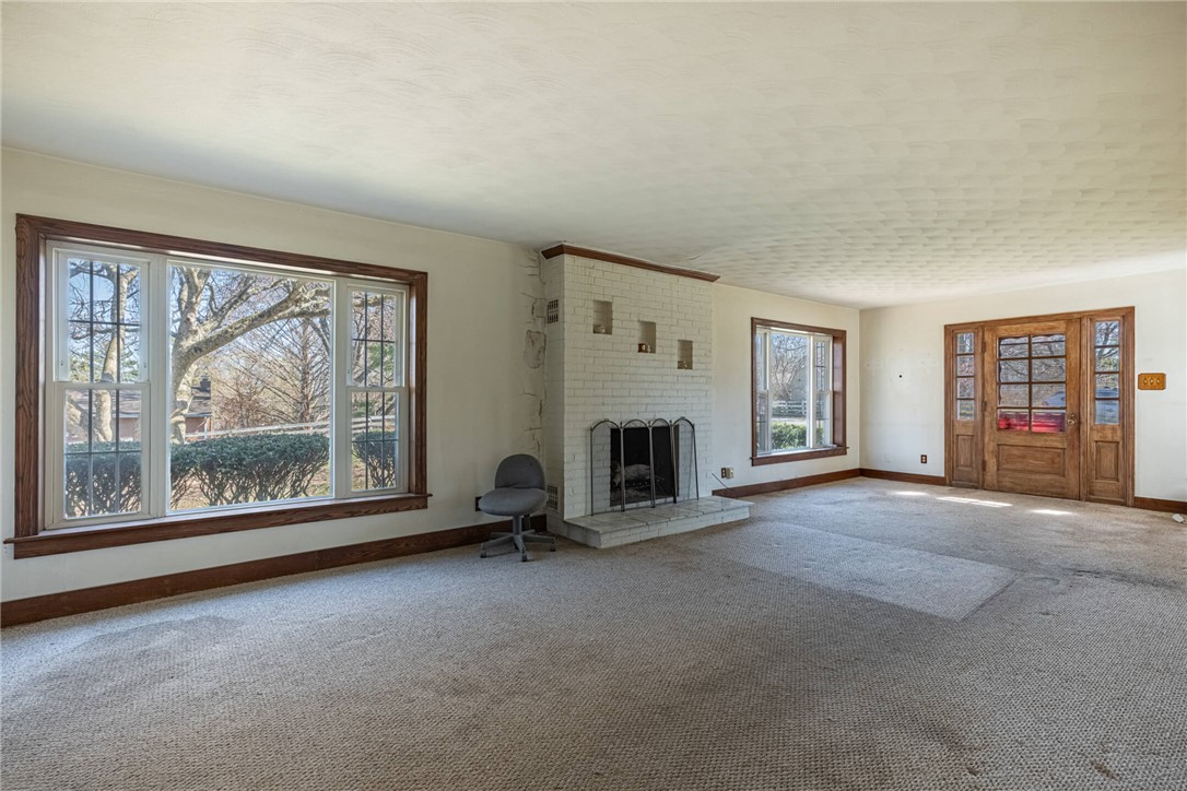 6885 Garber Road Clayton, OH 45415 - Photo 2 of 24 This spacious living area offers abundant natural light and a charming fireplace.