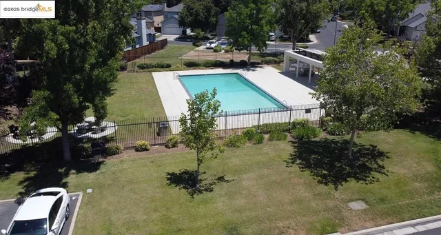 an aerial view of a house with a yard basket ball court and outdoor seating