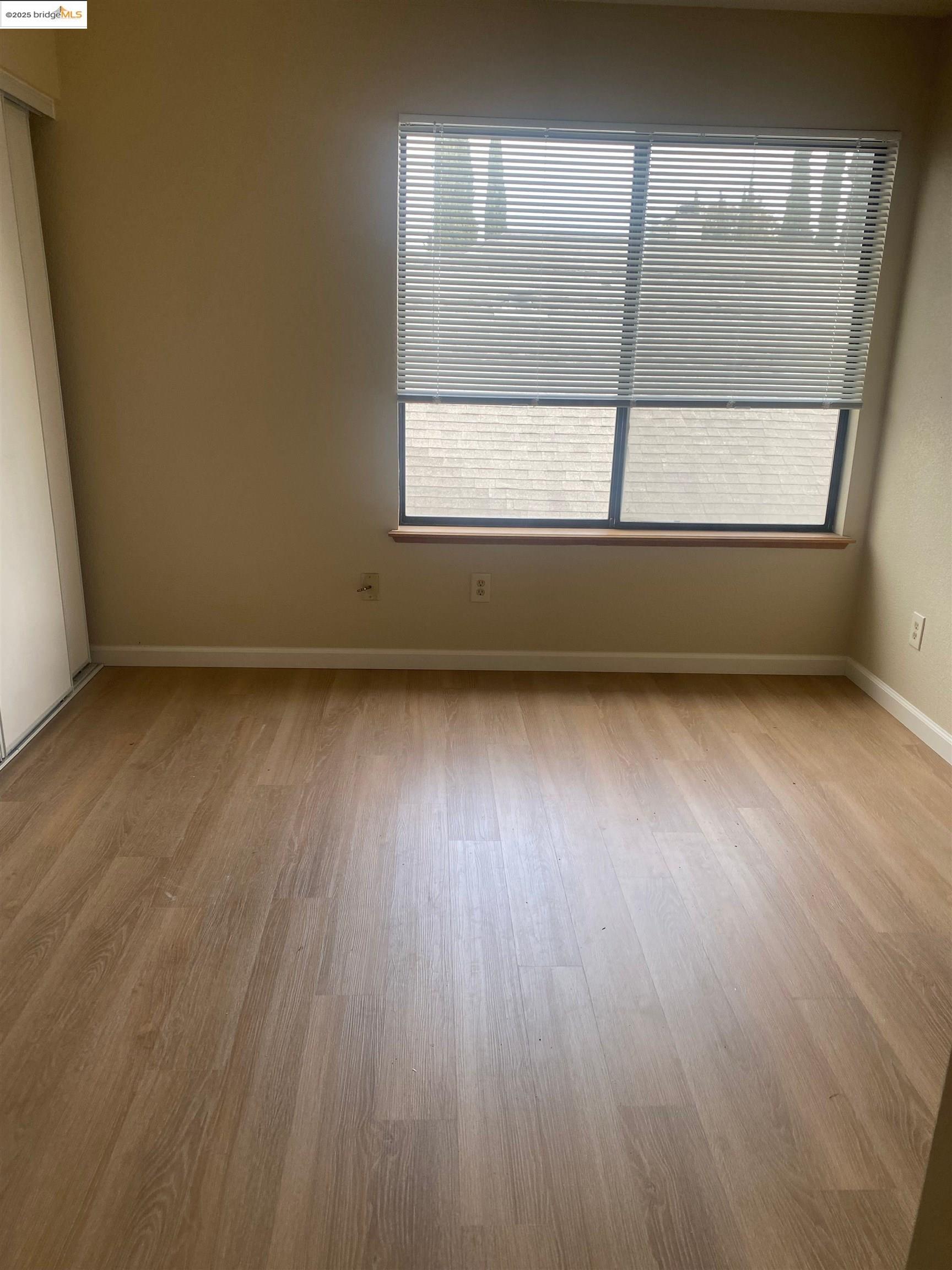 720 Timberline Terrace Brentwood, CA 94513 - Photo 2 of 12 an empty room with wooden floor and windows